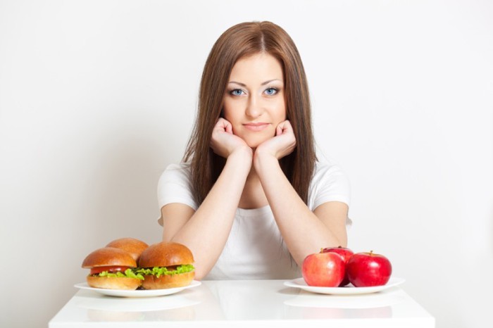 девушка с гамбургерами и яблоками